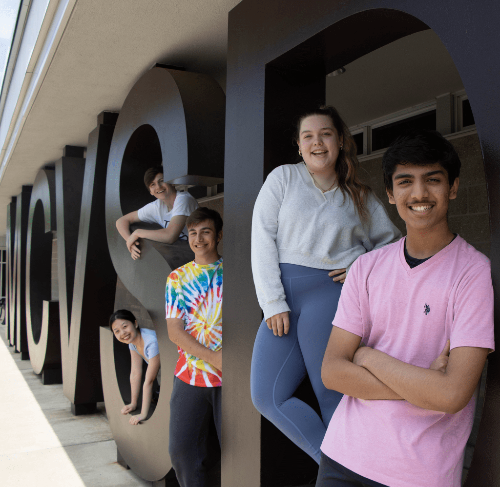 Five teenagers standing beside MCVSD letters 